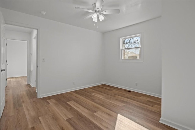 spare room featuring ceiling fan and light hardwood / wood-style floors