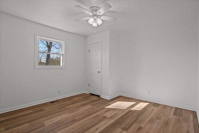 spare room featuring light hardwood / wood-style flooring and ceiling fan