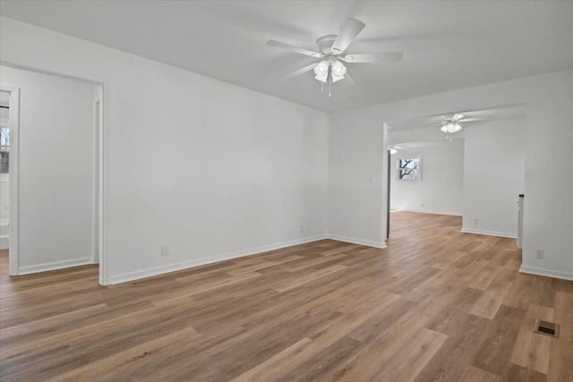 spare room with light wood-type flooring and ceiling fan