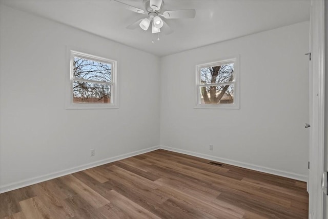 spare room featuring wood-type flooring and ceiling fan