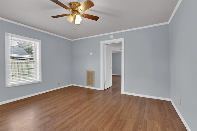 unfurnished room featuring wood-type flooring, ceiling fan, and ornamental molding