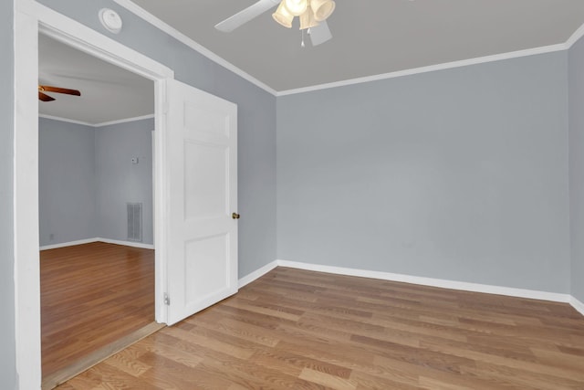 empty room with ceiling fan, ornamental molding, and light wood-type flooring