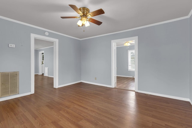 spare room featuring dark wood-type flooring, ceiling fan, and ornamental molding