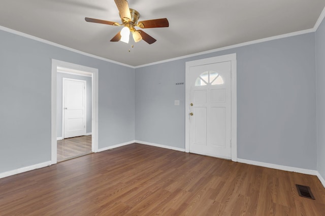 foyer featuring wood-type flooring, ceiling fan, and ornamental molding