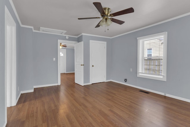 unfurnished room with ceiling fan, dark hardwood / wood-style flooring, and ornamental molding