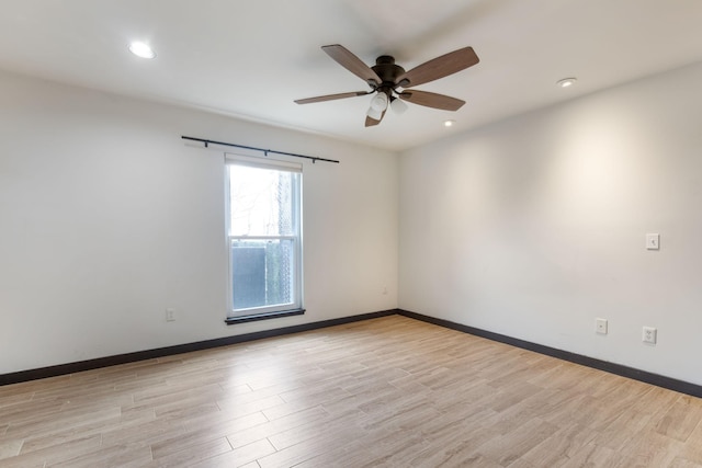 empty room with light wood-type flooring and ceiling fan