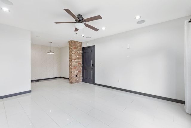 empty room with light tile patterned floors and ceiling fan