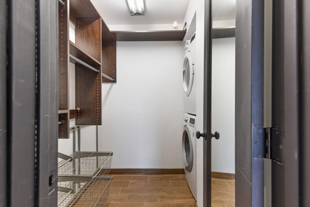 clothes washing area with stacked washer and dryer