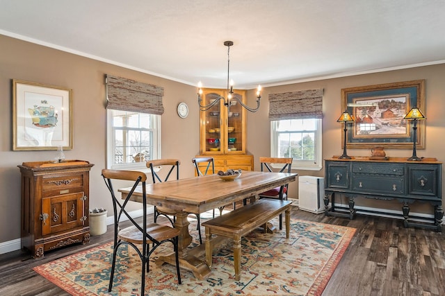 dining room featuring ornamental molding, dark wood-type flooring, and an inviting chandelier