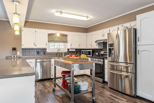 kitchen with white cabinets, hanging light fixtures, appliances with stainless steel finishes, and sink