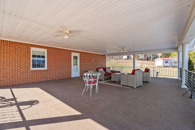 view of patio / terrace featuring ceiling fan, outdoor lounge area, and a storage shed