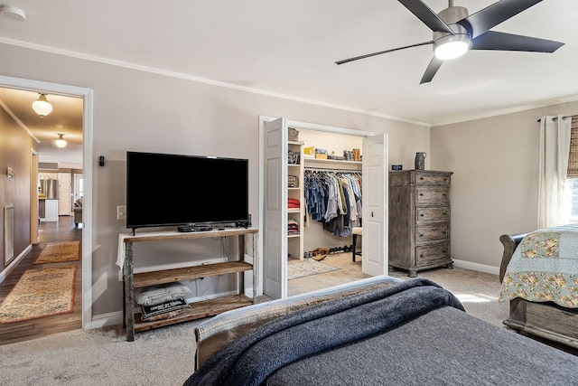 carpeted bedroom featuring a closet, ceiling fan, and ornamental molding