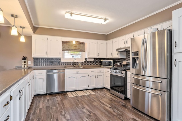 kitchen featuring sink, white cabinets, pendant lighting, and stainless steel appliances