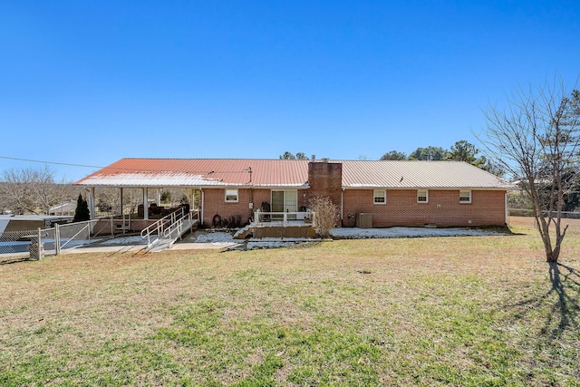 back of house featuring cooling unit, a patio area, and a yard