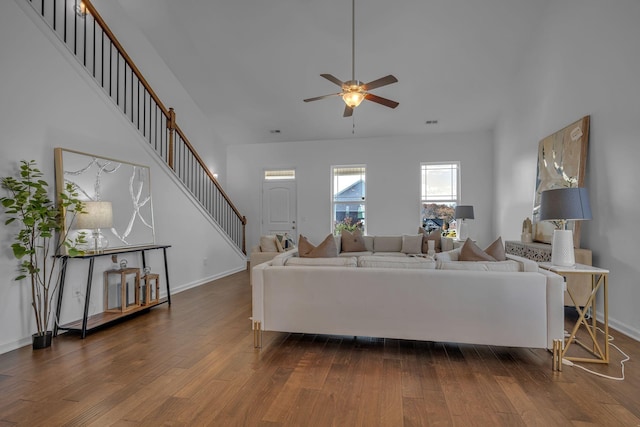 living room featuring dark wood-type flooring and ceiling fan