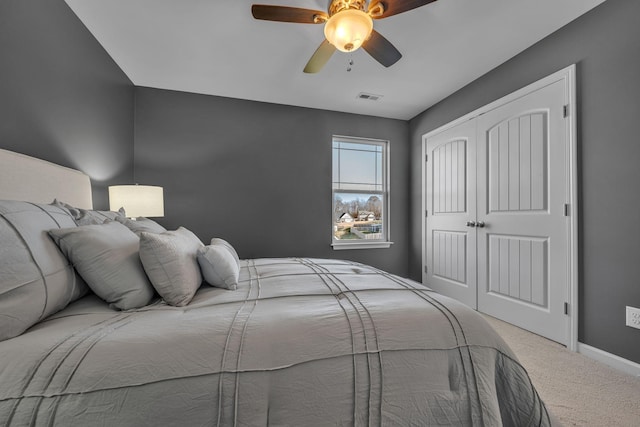 carpeted bedroom featuring a closet and ceiling fan