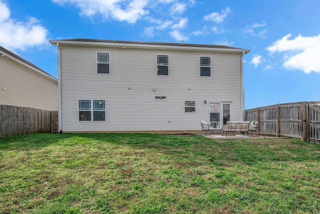 rear view of house with a patio area and a lawn