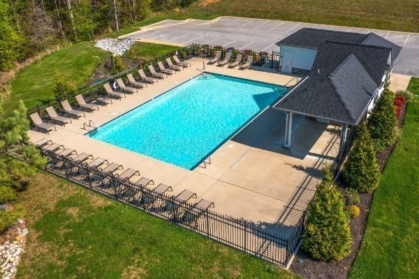 view of swimming pool featuring a lawn and a patio