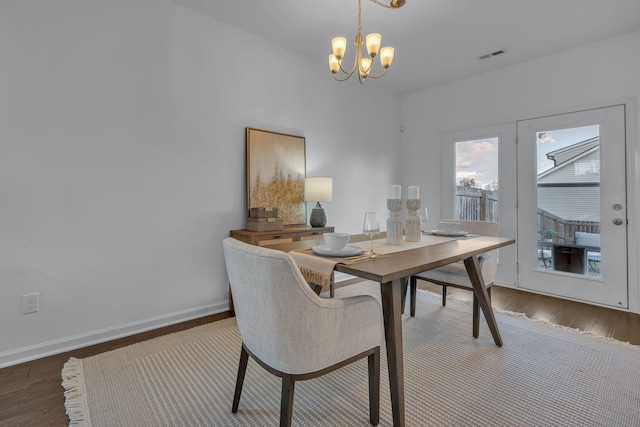 dining room with an inviting chandelier and dark hardwood / wood-style floors