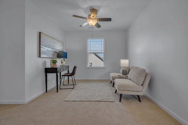 sitting room featuring ceiling fan and light carpet