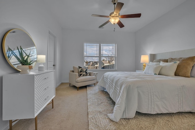 bedroom featuring ceiling fan and light carpet