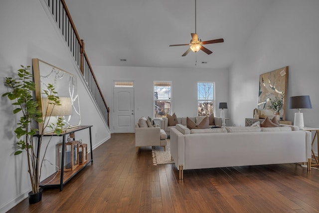 living room featuring dark wood-type flooring and ceiling fan