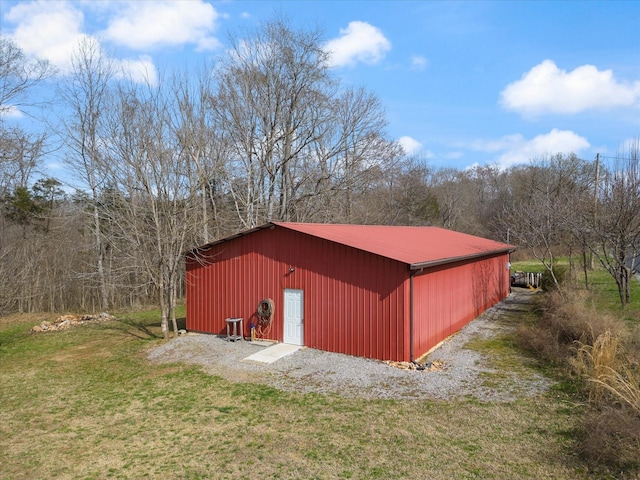 view of outbuilding featuring a lawn