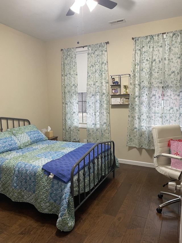 bedroom with dark wood-type flooring and ceiling fan