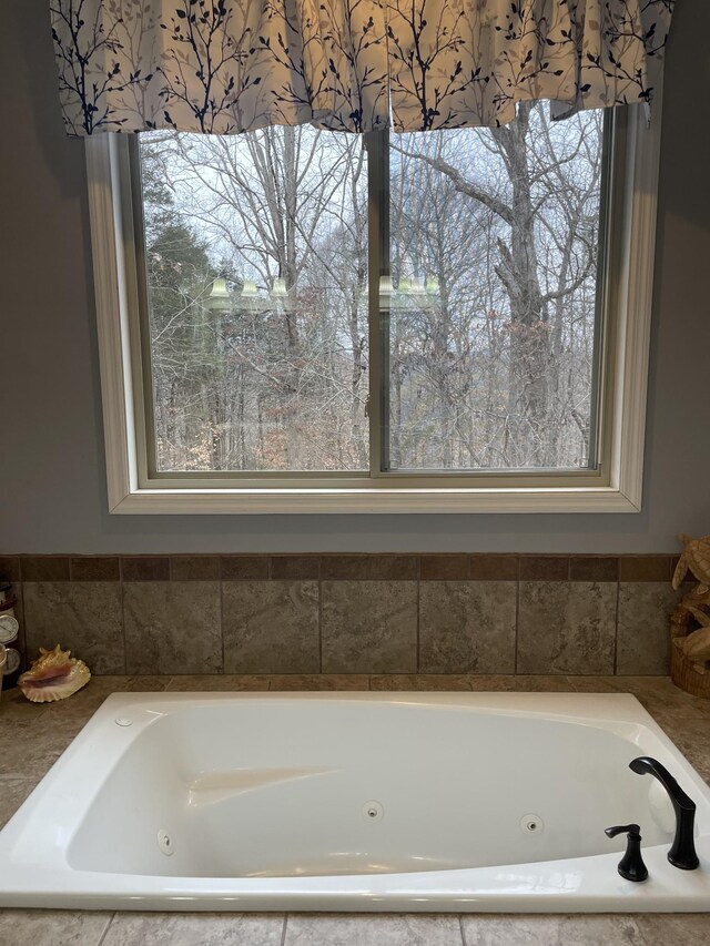 bathroom with a relaxing tiled tub