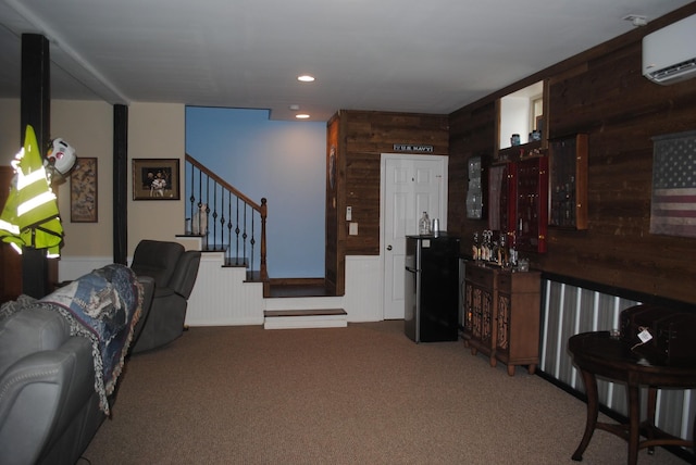 living room with wood walls, a wall mounted AC, and carpet flooring