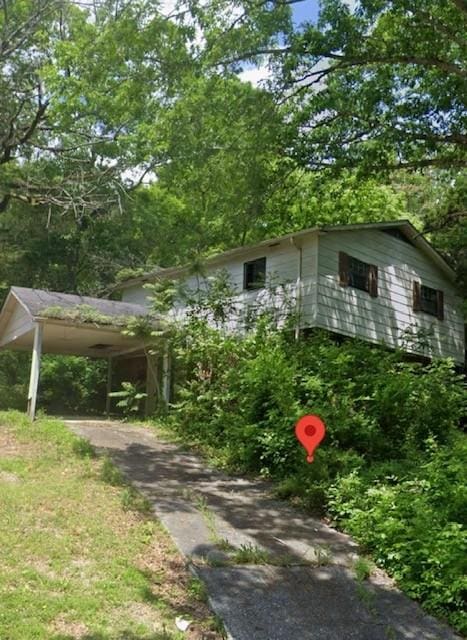 view of side of property with a carport