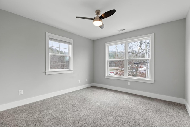 spare room with ceiling fan, carpet, and a healthy amount of sunlight