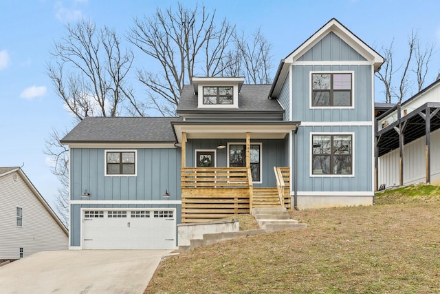 view of front of property with covered porch, a garage, and a front lawn