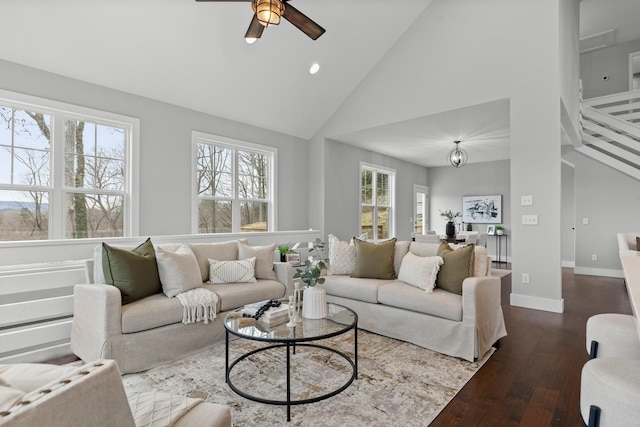 living room with wood-type flooring, a healthy amount of sunlight, high vaulted ceiling, and ceiling fan