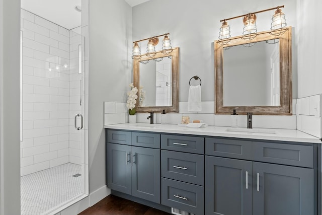 bathroom featuring hardwood / wood-style floors, a shower with shower door, and vanity