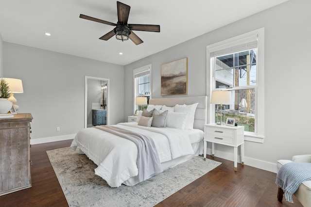 bedroom featuring ceiling fan, dark wood-type flooring, and ensuite bath