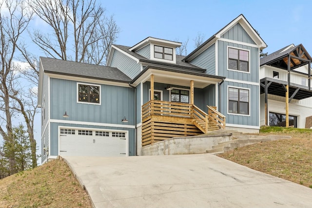 view of front of property featuring a porch, a garage, and a front yard