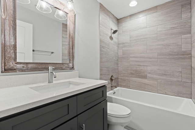 full bathroom with tiled shower / bath combo, vanity, and toilet