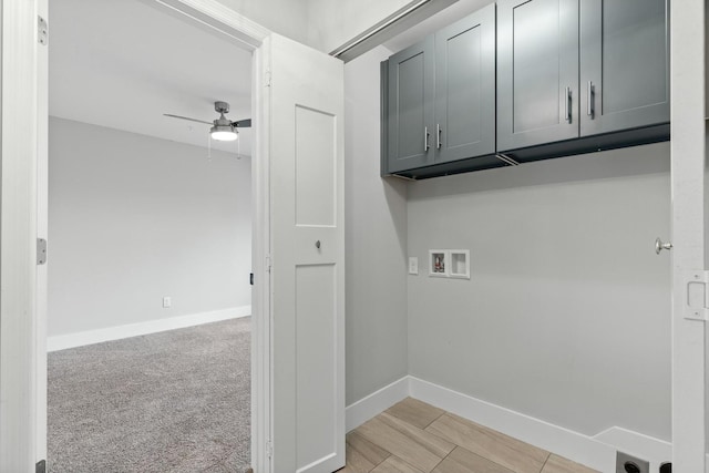 washroom with hookup for a washing machine, ceiling fan, light colored carpet, and cabinets