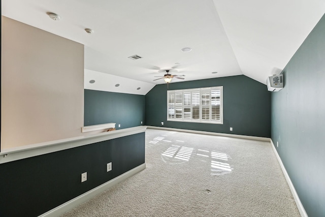 interior space with ceiling fan, carpet flooring, and lofted ceiling