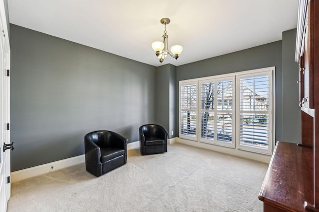 sitting room featuring light carpet and an inviting chandelier