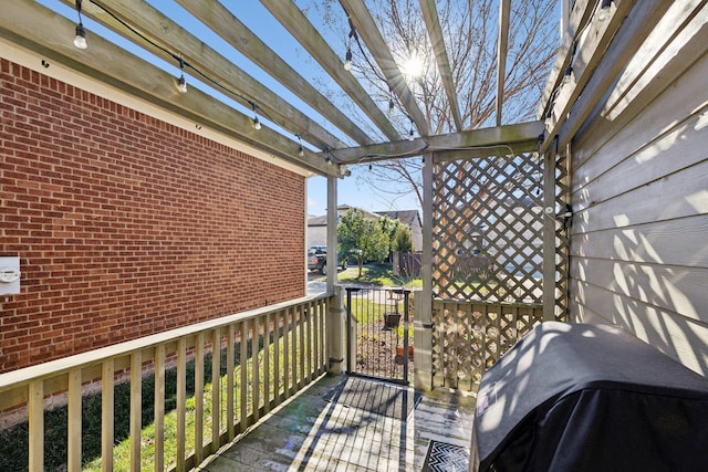 wooden balcony featuring area for grilling and a wooden deck