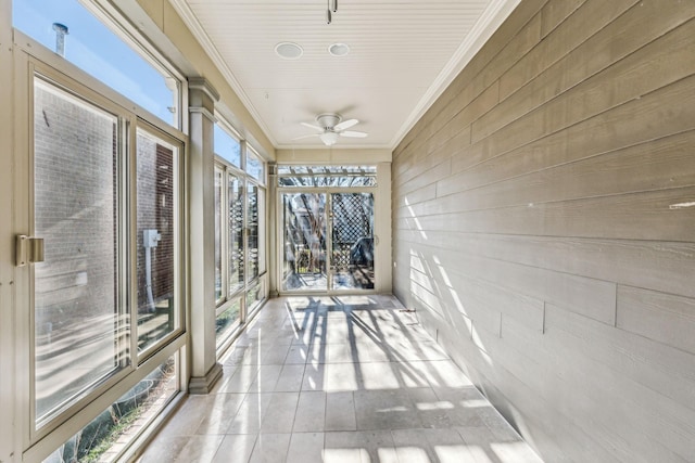 unfurnished sunroom featuring ceiling fan