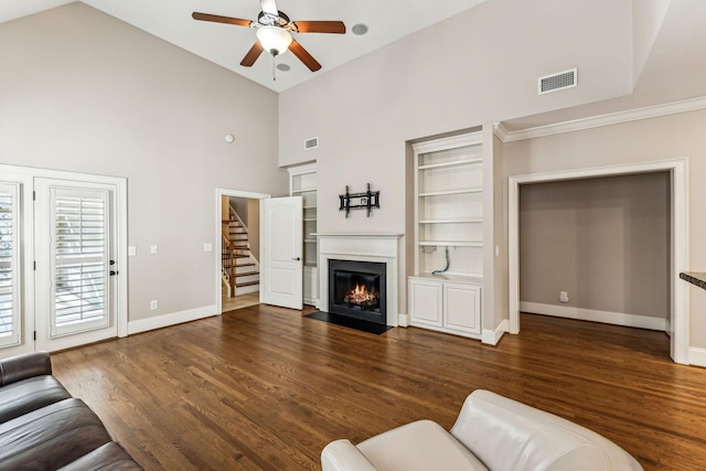 living room featuring ceiling fan, built in features, and dark hardwood / wood-style flooring