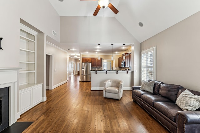 living room with built in features, ceiling fan, dark hardwood / wood-style floors, and lofted ceiling