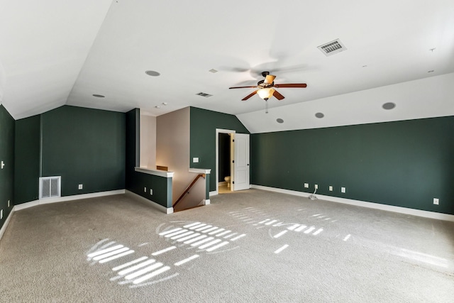 unfurnished living room featuring carpet floors, ceiling fan, and vaulted ceiling