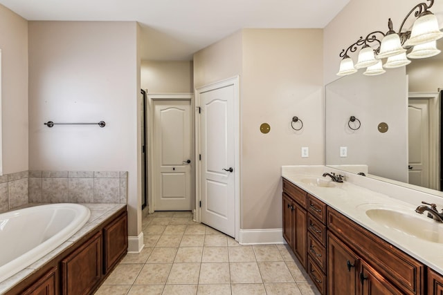 bathroom with vanity, a tub, and tile patterned floors