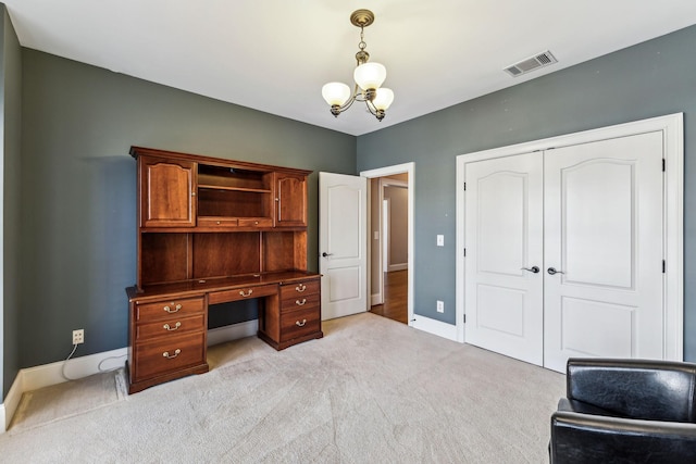 carpeted office featuring a chandelier