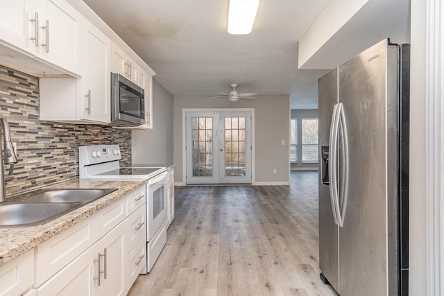 kitchen with white cabinets, sink, french doors, backsplash, and stainless steel appliances