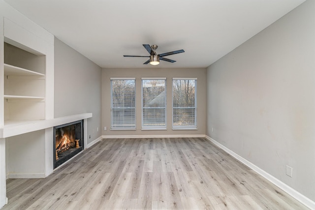 unfurnished living room with ceiling fan and light hardwood / wood-style flooring